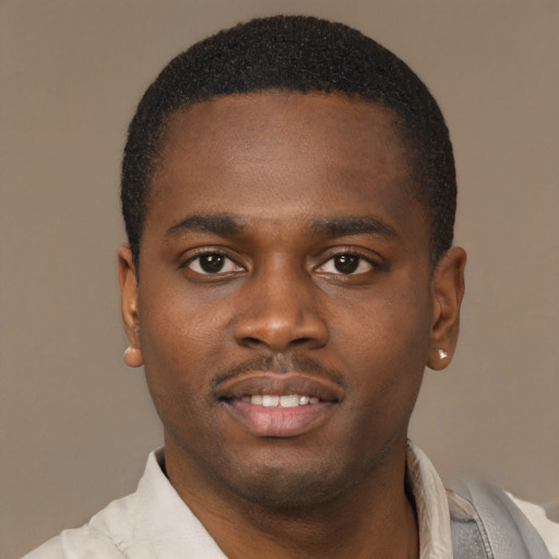 Joyful latino young-adult male with short  brown hair and brown eyes