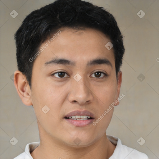 Joyful latino young-adult male with short  brown hair and brown eyes