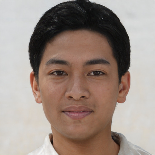 Joyful asian young-adult male with short  black hair and brown eyes
