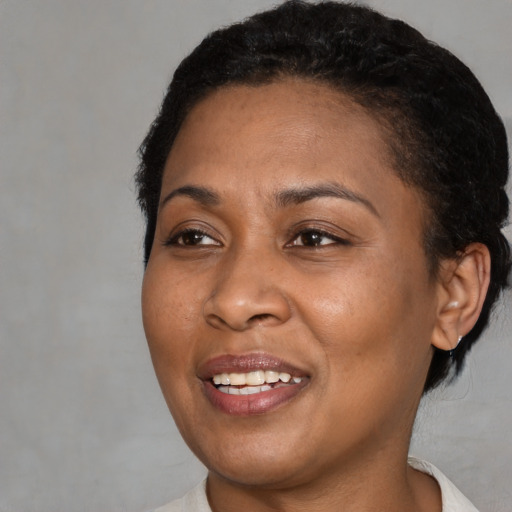 Joyful black young-adult female with short  brown hair and brown eyes