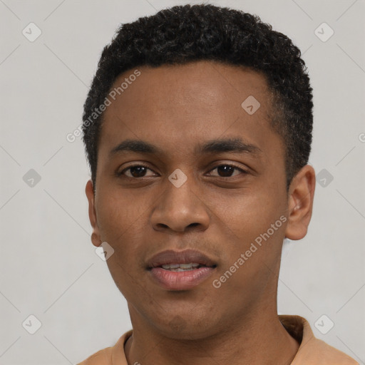 Joyful black young-adult male with short  black hair and brown eyes