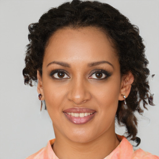 Joyful black young-adult female with medium  brown hair and brown eyes