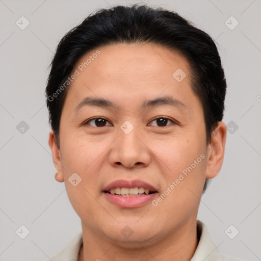 Joyful asian adult male with short  brown hair and brown eyes