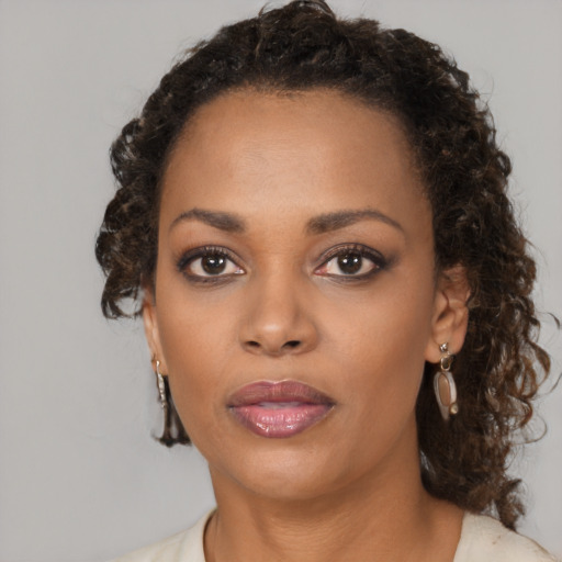 Neutral black young-adult female with medium  brown hair and brown eyes