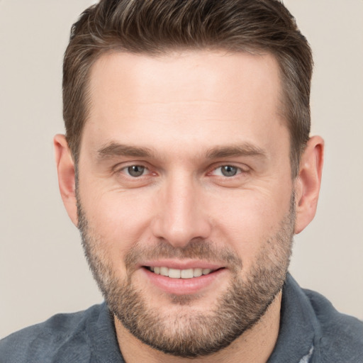 Joyful white adult male with short  brown hair and brown eyes