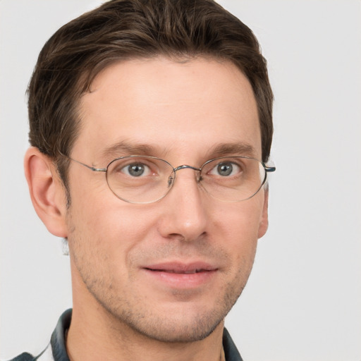 Joyful white adult male with short  brown hair and grey eyes