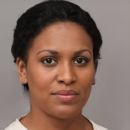Joyful black young-adult female with short  brown hair and brown eyes