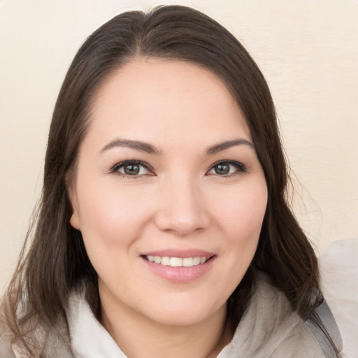 Joyful white young-adult female with medium  brown hair and brown eyes