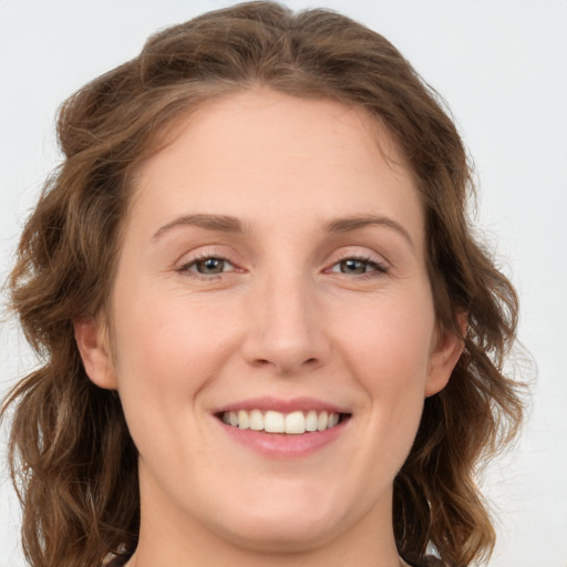 Joyful white young-adult female with medium  brown hair and green eyes