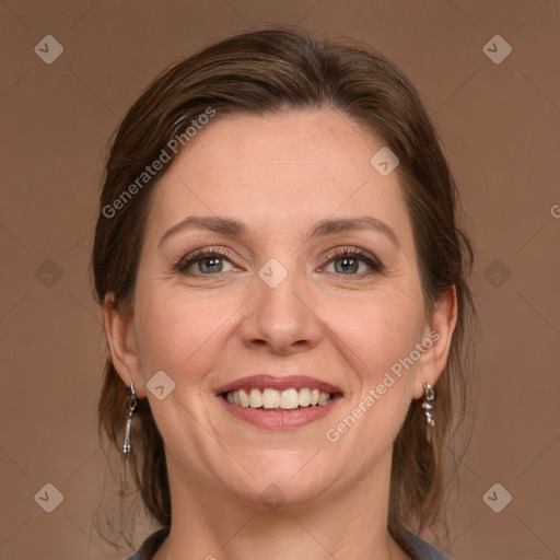 Joyful white adult female with medium  brown hair and grey eyes