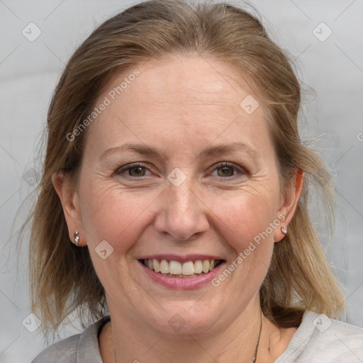 Joyful white adult female with medium  brown hair and blue eyes