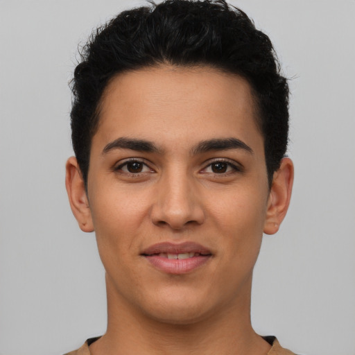 Joyful latino young-adult male with short  black hair and brown eyes