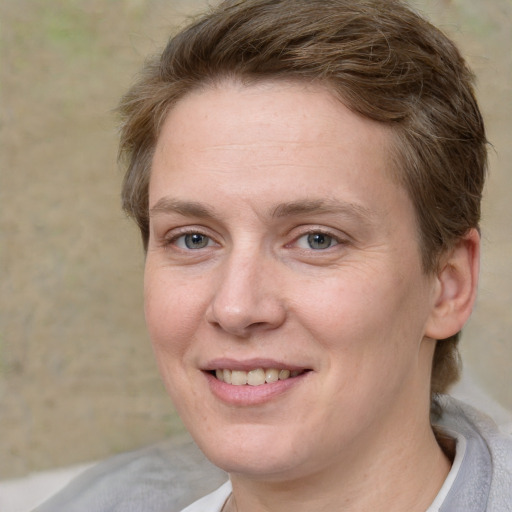 Joyful white adult female with medium  brown hair and grey eyes