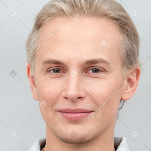 Joyful white adult male with short  brown hair and brown eyes