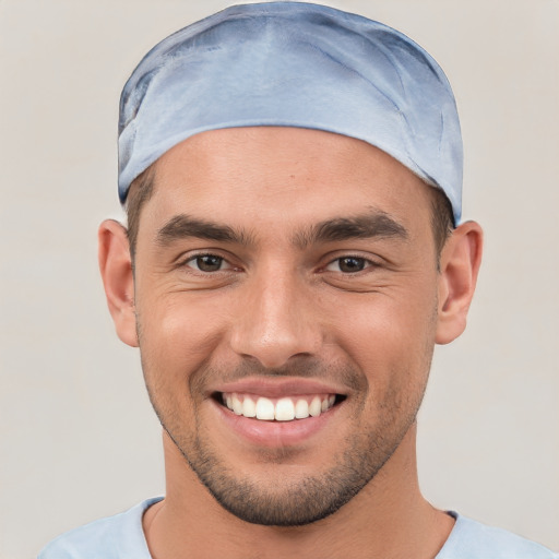 Joyful white young-adult male with short  brown hair and brown eyes