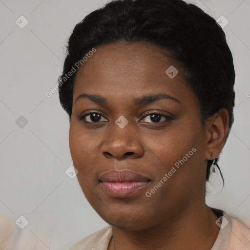 Joyful black young-adult female with short  black hair and brown eyes