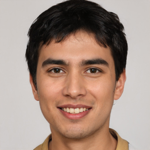 Joyful white young-adult male with short  black hair and brown eyes