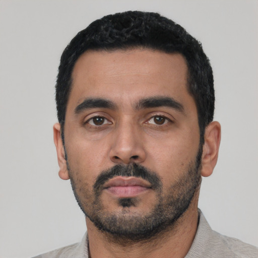 Neutral latino young-adult male with short  black hair and brown eyes