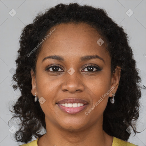 Joyful black young-adult female with long  brown hair and brown eyes