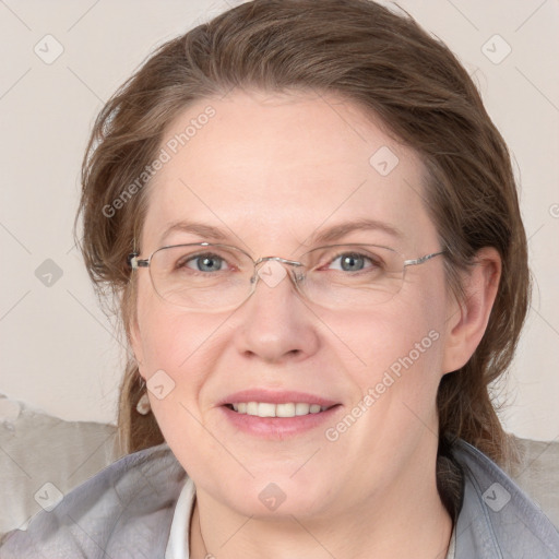 Joyful white adult female with medium  brown hair and blue eyes