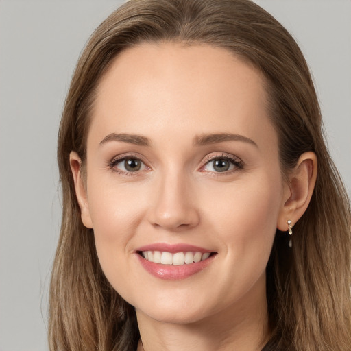 Joyful white young-adult female with long  brown hair and grey eyes