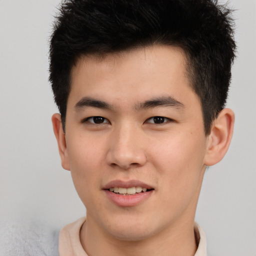 Joyful asian young-adult male with short  brown hair and brown eyes