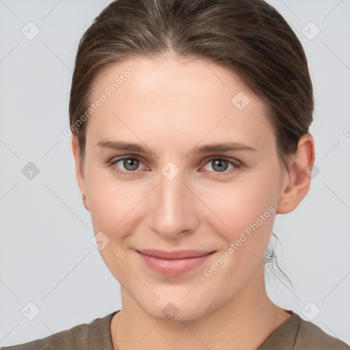 Joyful white young-adult female with short  brown hair and grey eyes