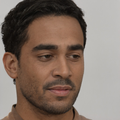Neutral latino young-adult male with short  black hair and brown eyes