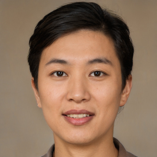 Joyful asian young-adult female with short  black hair and brown eyes