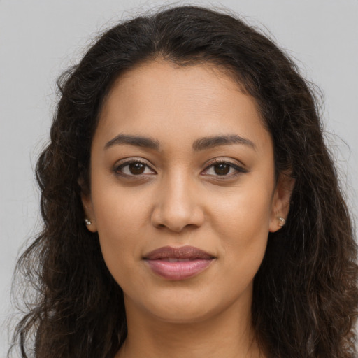 Joyful latino young-adult female with long  brown hair and brown eyes