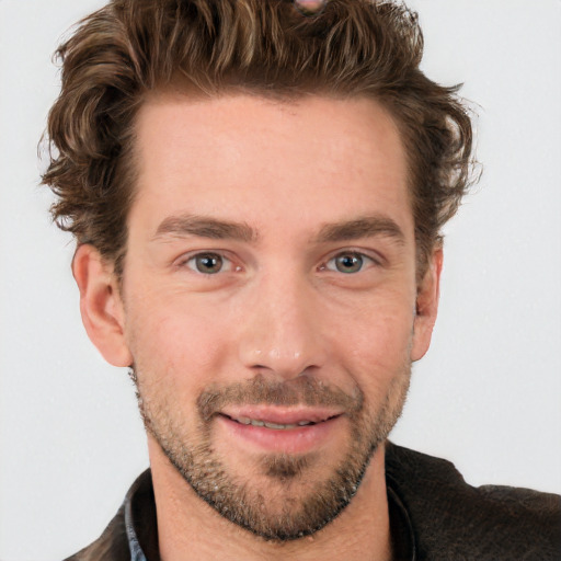 Joyful white young-adult male with short  brown hair and blue eyes