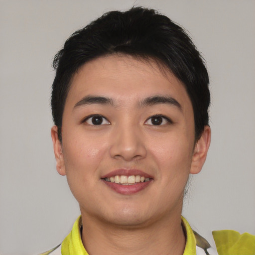 Joyful asian young-adult male with short  black hair and brown eyes