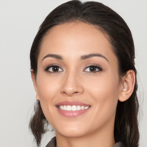 Joyful white young-adult female with long  brown hair and brown eyes