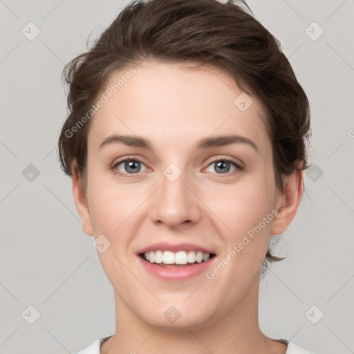 Joyful white young-adult female with short  brown hair and grey eyes