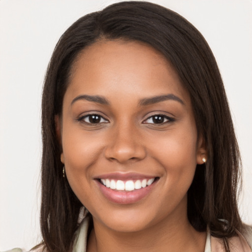 Joyful latino young-adult female with long  brown hair and brown eyes