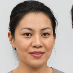 Joyful asian young-adult female with medium  brown hair and brown eyes