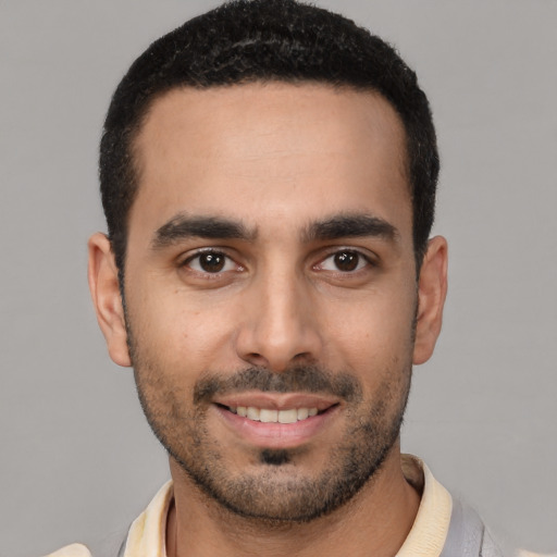 Joyful white young-adult male with short  black hair and brown eyes