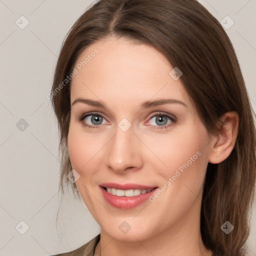 Joyful white young-adult female with medium  brown hair and grey eyes