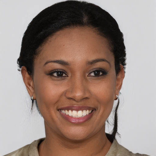 Joyful black young-adult female with medium  black hair and brown eyes