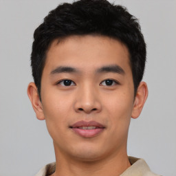 Joyful asian young-adult male with short  black hair and brown eyes