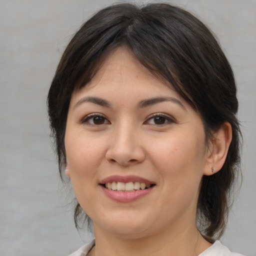 Joyful white young-adult female with medium  brown hair and brown eyes