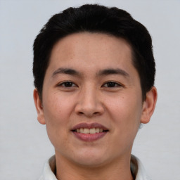 Joyful asian young-adult male with short  black hair and brown eyes