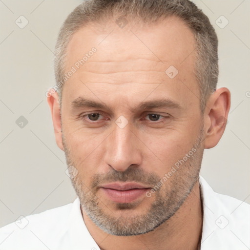 Joyful white adult male with short  brown hair and brown eyes