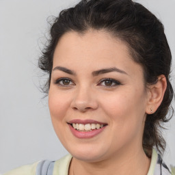 Joyful latino young-adult female with medium  brown hair and brown eyes