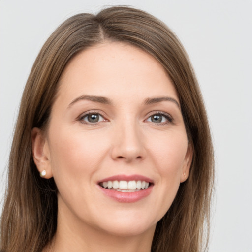 Joyful white young-adult female with long  brown hair and grey eyes