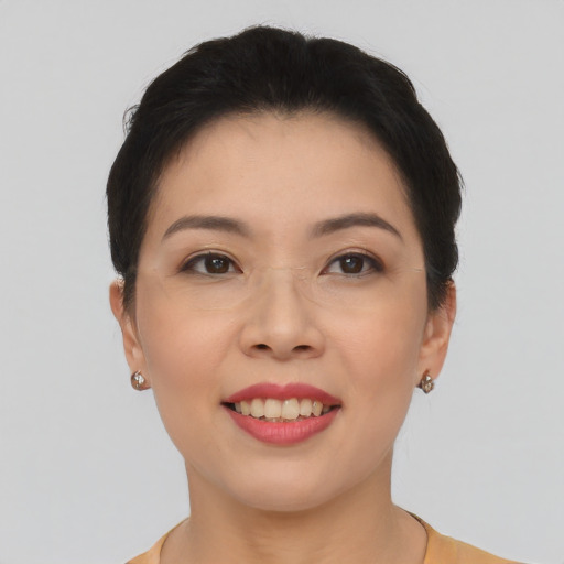 Joyful asian young-adult female with short  brown hair and brown eyes