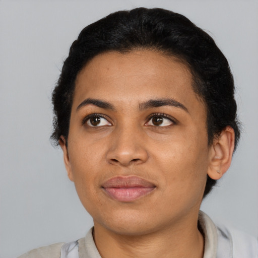 Joyful latino adult female with short  black hair and brown eyes