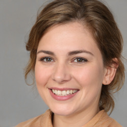 Joyful white young-adult female with medium  brown hair and brown eyes