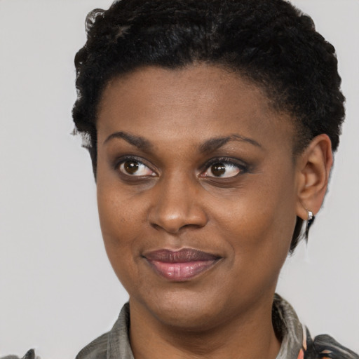 Joyful latino young-adult female with short  black hair and brown eyes
