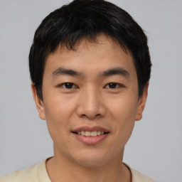 Joyful asian young-adult male with short  black hair and brown eyes